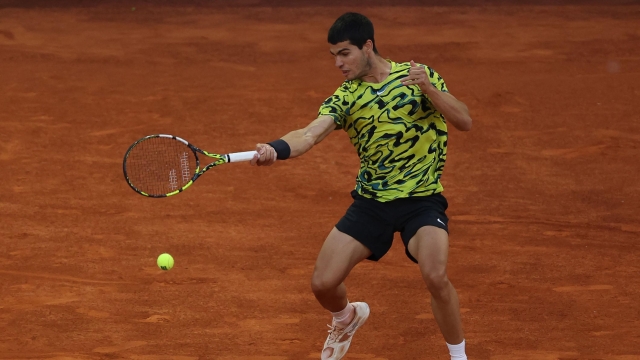 Spain's Carlos Alcaraz returns the ball to Germany's Jan-Lennard Struff during their 2023 ATP Tour Madrid Open tennis tournament singles final match at Caja Magica in Madrid on May 7, 2023. (Photo by Thomas COEX / AFP)