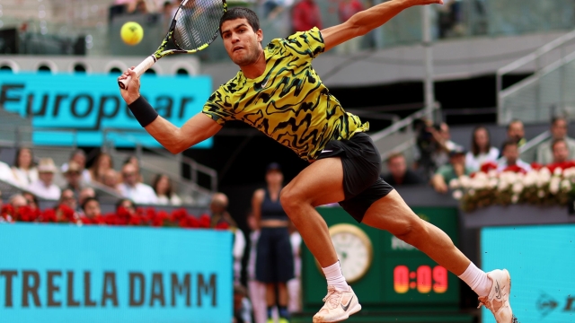 MADRID, SPAIN - MAY 07: Carlos Alcaraz of Spain plays a forehand  during the Men's Singles Final match against Jan-Lennard Struff of Germany on Day Fourteen of the Mutua Madrid Open at La Caja Magica on May 07, 2023 in Madrid, Spain. (Photo by Clive Brunskill/Getty Images)