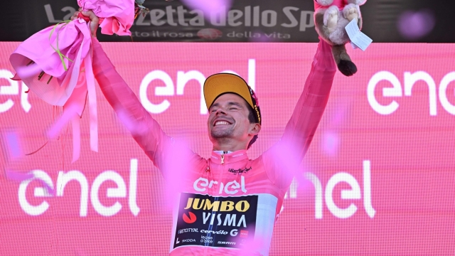 Slovenian rider  Primoz Roglic of team Jumbo Visma team wearing the overall leader's pink jersey celebrates on the podium the overall leader's pink jersey after  the twentyth stage ITT of the 2023 Giro d'Italia cycling race over  km 18,6 from Tarvisio to Monte Lussari, Italy, 27May 2023. ANSA/LUCA