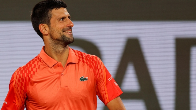 Serbia's Novak Djokovic celebrates after winning against Hungary's Marton Fucsovics at the end of their men's singles match on day four of the Roland-Garros Open tennis tournament at the Court Philippe-Chatrier in Paris on May 31, 2023. (Photo by Thomas SAMSON / AFP)