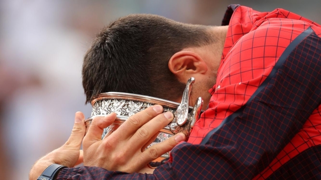 PARIS, FRANCE - JUNE 11:  Novak Djokovic of Serbia celebrates with the winners trophy after victory against Casper Ruud of Norway in the Men's Singles Final match on Day Fifteen of the 2023 French Open at Roland Garros on June 11, 2023 in Paris, France. (Photo by Julian Finney/Getty Images)