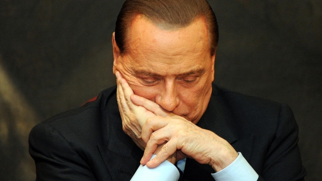 (FILES) In this file photo taken on February 01, 2012 Italy's former Prime Minister Silvio Berlusconi reacts during the presentation of Antonio Razzi's book "Le mie mani pulite" (My clean hands) at the Italian parliament in Rome. Silvio Berlusconi, the former prime minister who reshaped Italy's political and cultural landscape has died aged 86, his spokesman confirmed to AFP on June 12, 2023. (Photo by Andreas SOLARO / AFP)