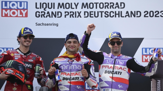 Spain's Jorge Martin, of the Prima Pramac Racing team, center, winner of the German Grand Prix, celebrates on the podium with second-placed Italy's Lorenzo Bagnaia, left, and third-placed Johann Zarco, at the Sachsenring racing circuit, in Hohenstein-Ernstthal, Germany, Sunday, June 18, 2023. (Jan Woitas/dpa via AP)