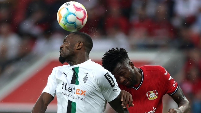LEVERKUSEN, GERMANY - MAY 21: Marcus Thuram of Borussia Moenchengladbach and Edmond Tapsoba of Bayer 04 Leverkusen battle for a header during the Bundesliga match between Bayer 04 Leverkusen and Borussia Mönchengladbach at BayArena on May 21, 2023 in Leverkusen, Germany. (Photo by Lars Baron/Getty Images)