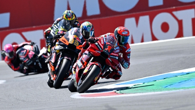 Ducati Lenovo Team's Italian rider Francesco Bagnaia competes ahead of Red Bull KTM Factory Racing's South African rider Brad Binder during the Dutch MotoGP at the TT circuit of Assen, on June 25, 2023. (Photo by John THYS / AFP)