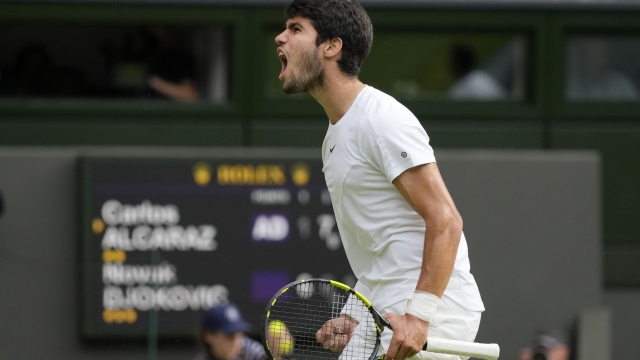 Spain's Carlos Alcaraz celebrates after winning a point against Serbia's Novak Djokovic in the final of the men's singles on day fourteen of the Wimbledon tennis championships in London, Sunday, July 16, 2023. (AP Photo/Kirsty Wigglesworth)