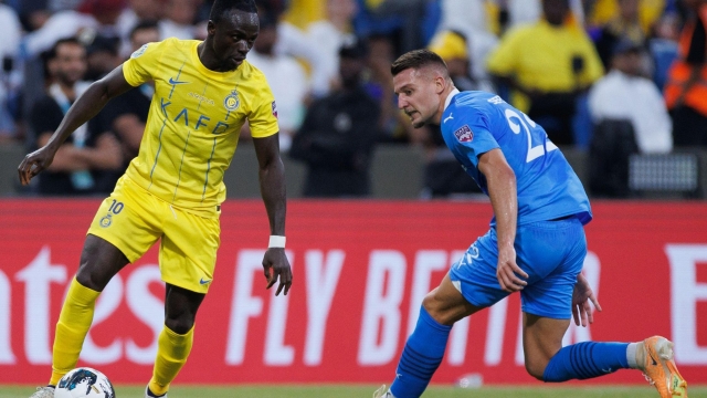 Nassr's Senegalese Forward #10 Sadio Mane is marked by Hilal's Serbian midfielder #22 Sergej Milinkovic-Savic during the 2023 Arab Club Champions Cup final football match between Saudi Arabia's Al-Hilal and Al-Nassr at the King Fahd Stadium in Taif on August 12, 2023. (Photo by AFP)