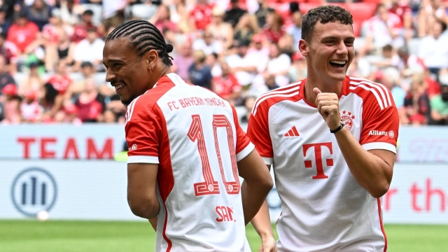 Bayern Munich's German midfielder Leroy Sane (L) and Bayern Munich's French defender Benjamin Pavard share a laugh during the team presentation of the German first division Bundesliga club Bayern Munich in the stadium in Munich, southern Germany, on July 23, 2023. (Photo by Christof STACHE / AFP)