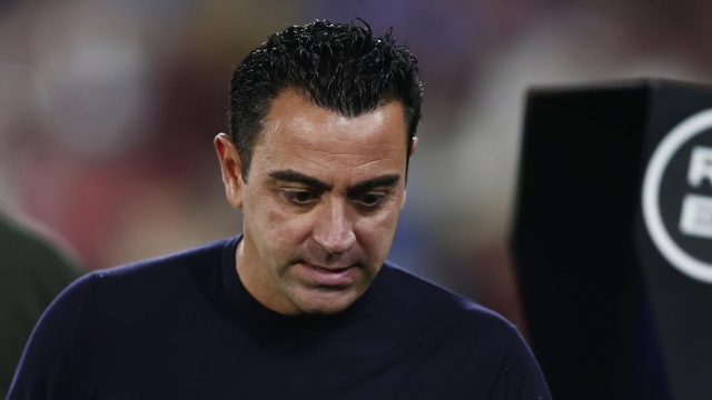 FILE - Barcelona's head coach Xavi Hernandez walks before the Spanish La Liga soccer match against Getafe at the Coliseum Alfonso Perez stadium in Getafe, Spain, Sunday, Aug. 13, 2023. Barcelona will be missing coach Xavi Hernandez and winger Raphinha for its first competitive game at its temporary home stadium. Barcelona hosts Cadiz at the Lluis Companys Olympic Stadium on Sunday, Aug. 20. (AP Photo/Alvaro Medranda, file)