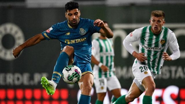 FC Porto's Iranian forward #09 Mehdi Taremi (L) vies with Rio Ave's Portuguese defender #20 Costinha  during the Portuguese league football match between Rio Ave FC and FC Porto at the Rio Ave FC - Dos Arcos stadium in Vila do Conde on August 28, 2023. (Photo by MIGUEL RIOPA / AFP)