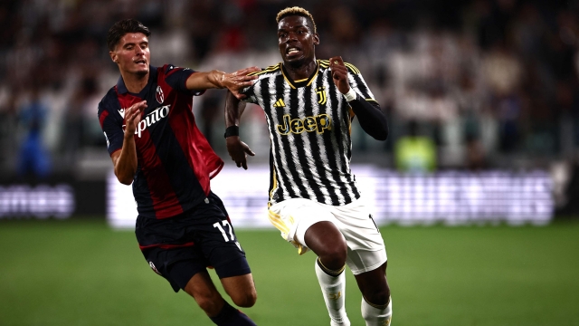 Bologna's Dutch-Moroccan midfielder #17 Oussama El Azzouzi (L) fights for the ball with Juventus French midfielder Paul Pogba during the Italian Serie A football match Juventus vs Bologna on August 27, 2023 at the Allianz Stadium in Turin. (Photo by MARCO BERTORELLO / AFP)