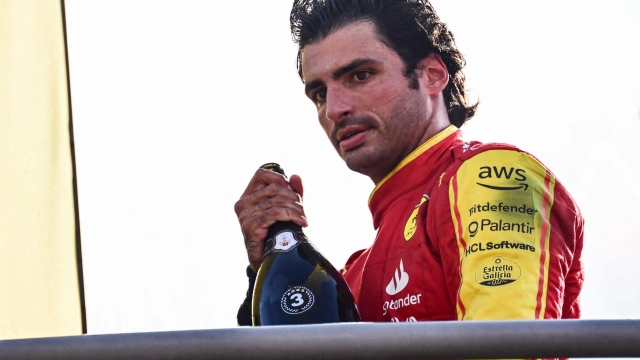 Ferrari's Spanish driver Carlos Sainz Jr looks on as he celebrates on the podium after the Italian Formula One Grand Prix race at Autodromo Nazionale Monza circuit, in Monza on September 3, 2023. (Photo by Ben Stansall / AFP)