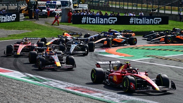 TOPSHOT - Ferrari's Spanish driver Carlos Sainz Jr (R) drives in front of Red Bull Racing's Dutch driver Max Verstappen and Ferrari's Monegasque driver Charles Leclerc (L) during the Italian Formula One Grand Prix race at Autodromo Nazionale Monza circuit, in Monza on September 3, 2023. (Photo by Ben Stansall / AFP)