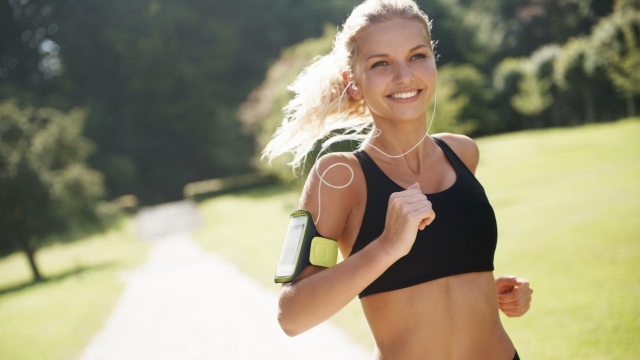 Fit and healthy female jogger running outdoors for her workout