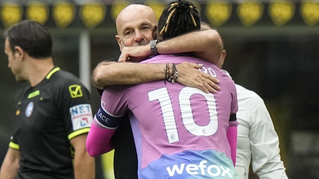 AC Milan's Rafael Leao celebrates with coach Stefano Pioli after scoring his side's opening goal during the Serie A soccer match between AC Milan and Hellas Verona at the San Siro stadium in Milan, Italy, Saturday, Sept. 23, 2023. (AP Photo/Luca Bruno)