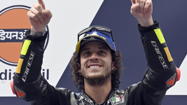DELHI, INDIA - SEPTEMBER 24:  Marco Bezzecchi of Italy and  Mooney VR46 Racing Team celebrates after winning first place on podium after MotoGP race of the Indian MotoGP Grand Prix at the Buddh International Circuit in Greater Noida on the outskirts of New Delhi, on September 24, 2023. (Photo by Prakash Singh/Getty Images)