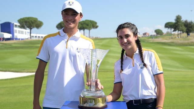 European team players Italian Francesca Fiorellini (R) and Giovanni Daniele Binaghi pose with the trophy on the 18th green after winning the Junior Ryder Cup ahead the 44th Ryder Cup at Marco Simone Golf Club in Guidonia, near Rome, Italy, 28 September 2023. The 44th Ryder Cup matches between the US and Europe will be held in Italy from 29 September to 01 October 2023.   ANSA/ETTORE FERRARI