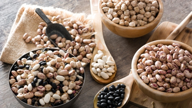 Assorted legumes on wooden background