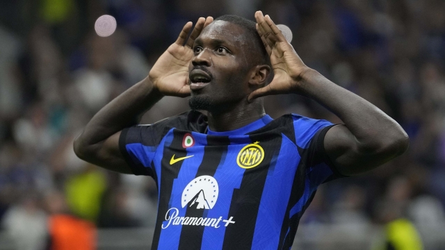 Inter Milan's Marcus Thuram celebrates after scoring his side's opening goal during the Champions League, Group D soccer match between Inter Milan and Benfica, at the San Siro stadium in Milan, Italy, Tuesday, Oct. 3, 2023. (AP Photo/Luca Bruno)