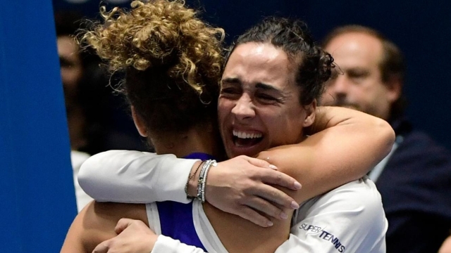 Italy's Jasmine Paolini celebrates with Italy's Martina Trevisan after winning the semifinal singles tennis match against Slovenia's Tamara Zidansek on the day 5 of the Billie Jean King Cup Finals 2023 in La Cartuja stadium in Seville on November 11, 2023. (Photo by CRISTINA QUICLER / AFP)