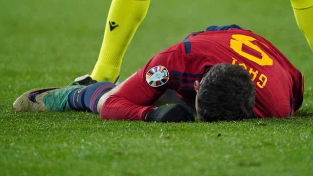 Spain's midfielder #09 Gavi lies on the lawn during the UEFA Euro 2024 group A qualifying football match between Spain and Georgia at the Jose Zorrilla stadium in Valladolid on November 19, 2023. (Photo by CESAR MANSO / AFP)