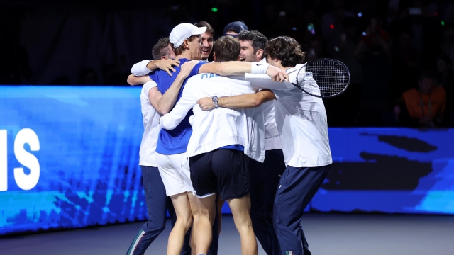 MALAGA, SPAIN - NOVEMBER 26: Jannik Sinner of Italy celebrates with teammates after winning match point during the Davis Cup Final match against Alex De Minaur of Australia at Palacio de Deportes Jose Maria Martin Carpena on November 26, 2023 in Malaga, Spain. (Photo by Clive Brunskill/Getty Images for ITF)