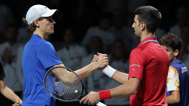 Italy's Jannik Sinner greets Serbia's Novak Djokovic after winning the second men's singles semifinal tennis match between Italy and Serbia of the Davis Cup tennis tournament at the Martin Carpena sportshall, in Malaga on November 25, 2023. (Photo by LLUIS GENE / AFP)