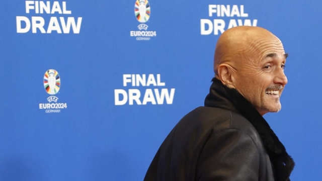 Italy's head coach Luciano Spalletti gestures as he walks over the red carpet upon arrival for the final draw for the UEFA Euro 2024 European Championship football competition in Hamburg, northern Germany on December 2, 2023. (Photo by Odd ANDERSEN / AFP)