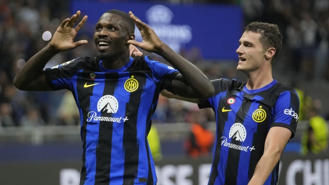 Inter Milan's Marcus Thuram, left, celebrates with his teammate Benjamin Pavard after scoring his side's opening goal during the Champions League, Group D soccer match between Inter Milan and Benfica, at the San Siro stadium in Milan, Italy, Tuesday, Oct. 3, 2023. (AP Photo/Luca Bruno)