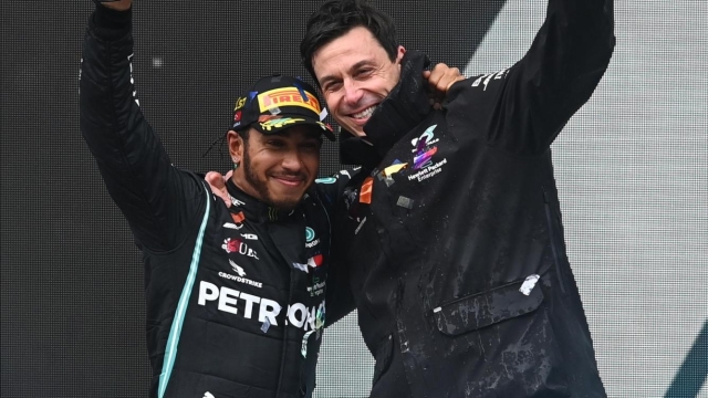 epa08821685 British Formula One driver Lewis Hamilton (L) of Mercedes-AMG Petronas and Mercedes-AMG Petronas team principal Toto Wolff (R) pose for a photo on the podium after the Formula One Grand of Turkey on the Intercity Istanbul Park circuit, Istanbul, Turkey, 15 November 2020.  EPA/Ozan Kose / Pool
