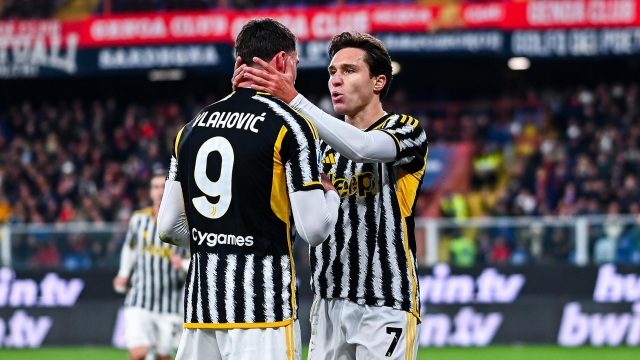 GENOA, ITALY - DECEMBER 15: Federico Chiesa of Juventus (right) celebrates with his team-mate Dusan Vlahovic after scoring a goal on a penalty kick during the Serie A TIM match between Genoa CFC and Juventus at Stadio Luigi Ferraris on December 15, 2023 in Genoa, Italy. (Photo by Simone Arveda/Getty Images)