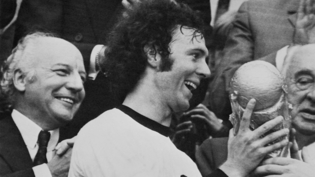 (FILES) West German captain Franz Beckenbauer holds the trophee after his team's victory at the World cup soccer final "West Germany - Holland" at Olympic Stadium in Munich on July 07, 1974. Franz Beckenbauer died aged 78 the German football association announced on January 8, 2024. (Photo by AFP)