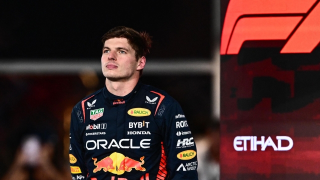 (FILES) Red Bull Racing's Dutch driver Max Verstappen poses on the podium after winning the Abu Dhabi Formula One Grand Prix at the Yas Marina Circuit in the Emirati city on November 26, 2023. (Photo by Jewel SAMAD / AFP)