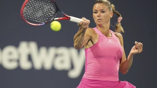 Camila Giorgi, of Italy, returns a volley against Victoria Azarenka, of Belarus, in the second set of a match at the Miami Open tennis tournament, Thursday, March 23, 2023, in Miami Gardens, Fla. (AP Photo/Jim Rassol)