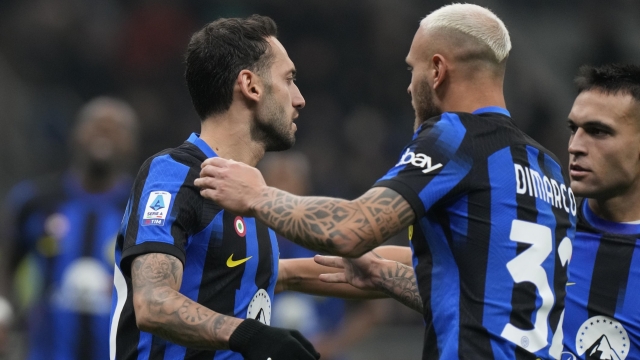 Inter Milan's Hakan Calhanoglu, left, celebrates with Inter Milan's Federico Dimarco after scoring his side's second goal during a Serie A soccer match between Inter Milan and Frosinone, at the San Siro stadium in Milan, Italy, Sunday, Nov. 12, 2023. (AP Photo/Luca Bruno)