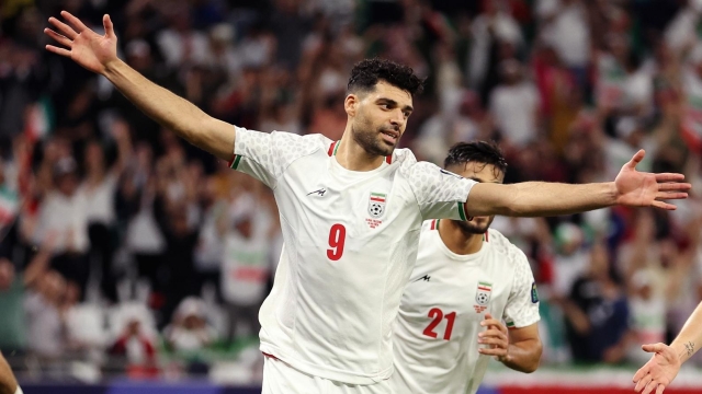 AL RAYYAN, QATAR - JANUARY 14: Sardar Azmoun of Iran celebrates with teammates Mehdi Taremi and Mohammad Mohebi of Iran after scoring their team's fourth goal  during the AFC Asian Cup Group C match between Iran and Palestine at Education City Stadium on January 14, 2024 in Al Rayyan, Qatar. (Photo by Robert Cianflone/Getty Images)