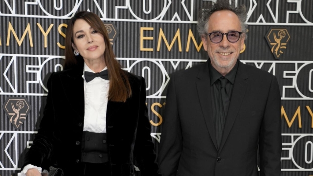 Monica Bellucci, left, and Tim Burton arrive at the 75th Primetime Emmy Awards on Monday, Jan. 15, 2024, at the Peacock Theater in Los Angeles. (AP Photo/Ashley Landis)