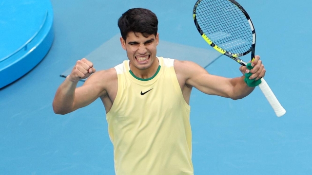 MELBOURNE, AUSTRALIA - JANUARY 18: Carlos Alcaraz of Spain celebrates match point in their round two singles match against Lorenzo Sonego of Italy during the 2024 Australian Open at Melbourne Park on January 18, 2024 in Melbourne, Australia. (Photo by Kelly Defina/Getty Images)