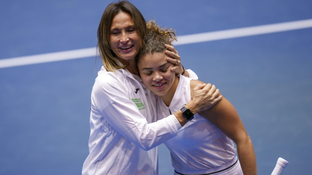 Italy's Jasmine Paolini, right, celebrates with Tathiana Garbin, captain of team Italy, after defeating France's Caroline Garcia during their group stage tennis match between France and Italy on the second day of the Billie Jean King Cup finals at La Cartuja stadium in Seville, southern Spain, Wednesday, Nov. 8, 2023. (AP Photo/Manu Fernandez)