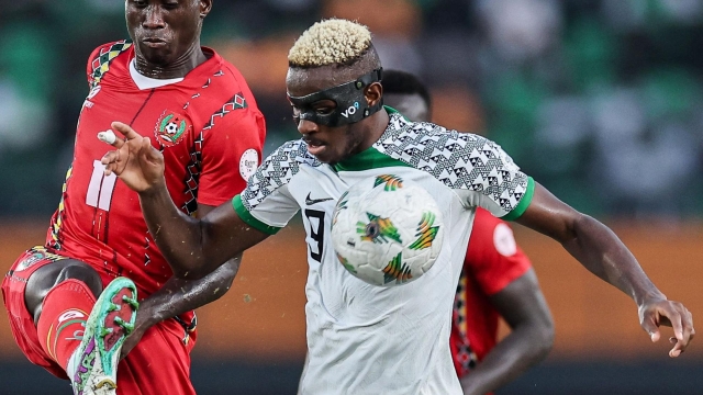 Guinea-Bissau's forward #11 Marciano Tchami (L) fights for the ball with Nigeria's forward #9 Victor Osimhen during the Africa Cup of Nations (CAN) 2024 group A football match between Guinea-Bissau and Nigeria at the Felix Houphouet-Boigny Stadium in Abidjan on January 22, 2024. (Photo by FRANCK FIFE / AFP)