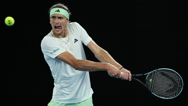 MELBOURNE, AUSTRALIA - JANUARY 24: Alexander Zverev of Germany plays a backhand during their quarterfinals singles match against Carlos Alcaraz of Spain during the 2024 Australian Open at Melbourne Park on January 24, 2024 in Melbourne, Australia. (Photo by Julian Finney/Getty Images)
