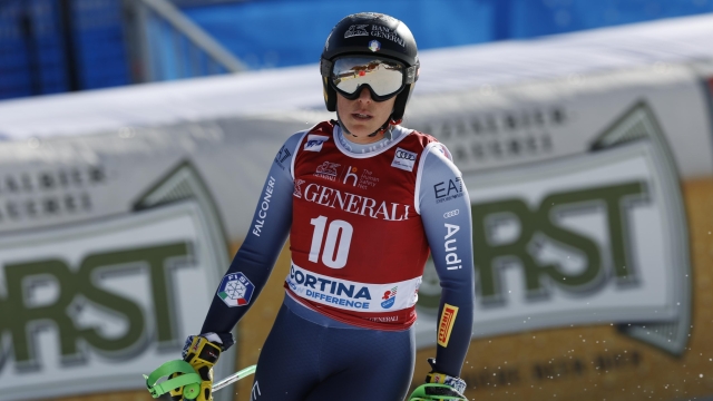 Italy's Federica Brignone arrives at the finish area after crashing during an alpine ski, women's World Cup downhill race, in Cortina d'Ampezzo, Italy, Friday, Jan. 26, 2024. (AP Photo/Alessandro Trovati)