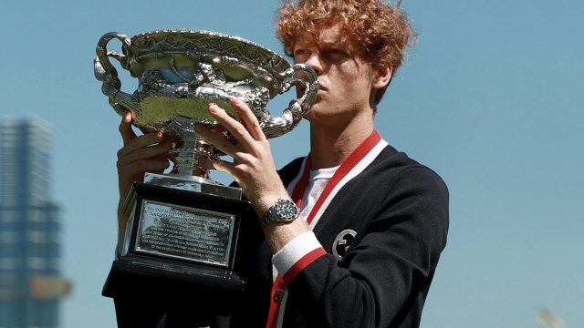 MELBOURNE, AUSTRALIA - JANUARY 29: (EDITOR'S NOTE: Image has a desaturated filter) Jannik Sinner of Italy poses with the Norman Brookes Challenge Cup after winning the 2024 Australian Open Final, at Royal Botanic Gardens on January 29, 2024 in Melbourne, Australia. (Photo by Kelly Defina/Getty Images)