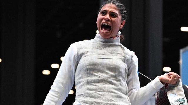 (FILES) France's Ysaora Thibus celebrates defeating Japan's Karin Miyawaki during the Foil Women's Senior Individual qualifiers as part of the FIE Fencing World Championships at the Fair Allianz MI.CO (Milano Convegni) in Milan, on July 26, 2023. France's Ysaora Thibus takes part with France's fencer Enzo Lefort (not in the picture), at the Challenge International de Paris (CIP), at the Pierre de Coubertin Stadium on January 13 and 14, 2024, as a "mini-test" prior to the Paris 2024 Olympic Games, in Paris, on January 12, 2024. (Photo by Andreas SOLARO / AFP)