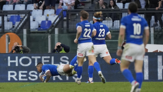 Italy's Monty Ioane dives over the line to score his sides third try during the Six Nations rugby union match between Italy and England at Rome's Olympic Stadium, Saturday, Feb. 3, 2024. (AP Photo/Andrew Medichini)