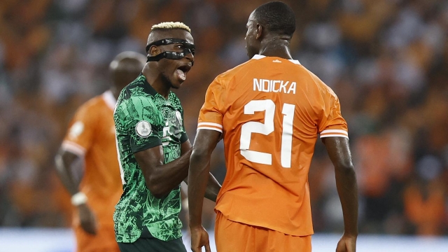 Nigeria's forward #9 Victor Osimhen argues with Ivory Coast's defender #21 Evan Ndicka during the Africa Cup of Nations (CAN) 2024 final football match between Ivory Coast and Nigeria at Alassane Ouattara Olympic Stadium in Ebimpe, Abidjan on February 11, 2024. (Photo by Daniel BELOUMOU OLOMO / AFP)