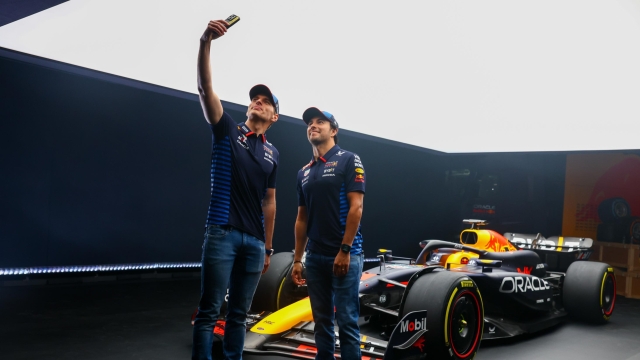 MILTON KEYNES, ENGLAND - FEBRUARY 15: Max Verstappen of the Netherlands and Oracle Red Bull Racing and Sergio Perez of Mexico and Oracle Red Bull Racing pose for a photo with the RB20 during the Oracle Red Bull Racing RB20 car launch at Red Bull Racing Factory on February 15, 2024 in Milton Keynes, England. (Photo by Mark Thompson/Getty Images for Red Bull Racing)