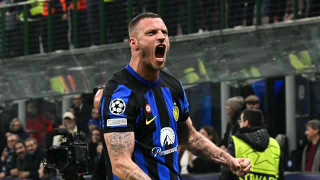 TOPSHOT - Inter Milan's Austrian forward #08 Marko Arnautovic celebrates after scoring the team's first goal during the UEFA Champions League last 16 first leg football match Inter Milan vs Atletico Madrid at the San Siro stadium in Milan on February 20, 2024. (Photo by GABRIEL BOUYS / AFP)