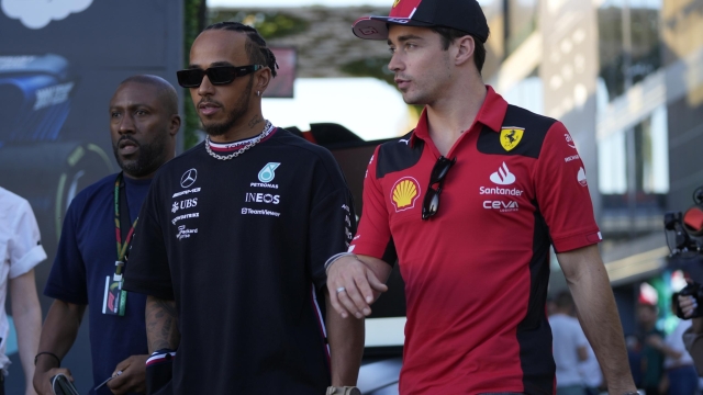 FILE - Mercedes driver Lewis Hamilton of Britain, left, and Ferrari driver Charles Leclerc of Monaco arrive to speak to media ahead of the Formula On Saudi Arabian Grand Prix in Jeddah, Saudi Arabia, Thursday, March 16, 2023. Lewis Hamilton's arrival will present ?a huge opportunity? for Ferrari next year but signing the seven-time Formula One champion involved some uncomfortable phone calls, team principal Fred Vasseur said Tuesday, Feb. 13, 2024. Hamilton is joining Ferrari for next season after driving for Mercedes since 2013. He will team up with Charles Leclerc at the Italian team after Carlos Sainz Jr. leaves. (AP Photo/Hassan Ammar, File)