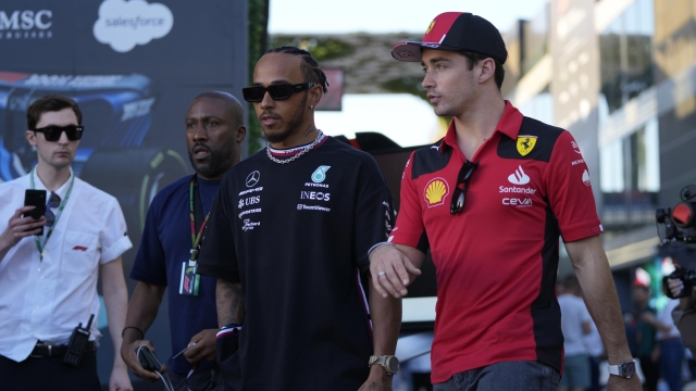 FILE - Mercedes driver Lewis Hamilton of Britain, left, and Ferrari driver Charles Leclerc of Monaco arrive to speak to media ahead of the Formula On Saudi Arabian Grand Prix in Jeddah, Saudi Arabia, Thursday, March 16, 2023. Lewis Hamilton's arrival will present ?a huge opportunity? for Ferrari next year but signing the seven-time Formula One champion involved some uncomfortable phone calls, team principal Fred Vasseur said Tuesday, Feb. 13, 2024. Hamilton is joining Ferrari for next season after driving for Mercedes since 2013. He will team up with Charles Leclerc at the Italian team after Carlos Sainz Jr. leaves. (AP Photo/Hassan Ammar, File)